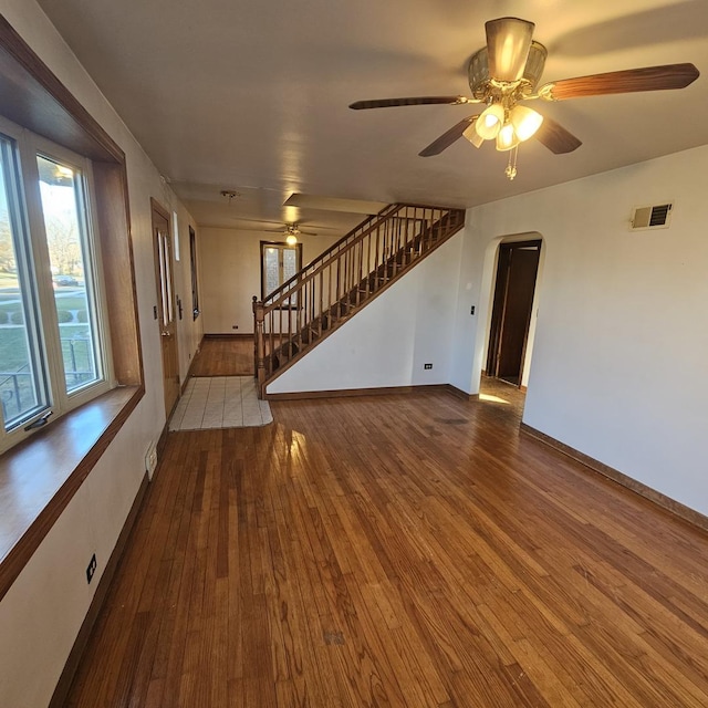 unfurnished living room featuring ceiling fan and hardwood / wood-style floors