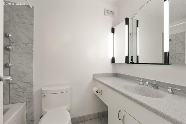 bathroom featuring vanity and toilet