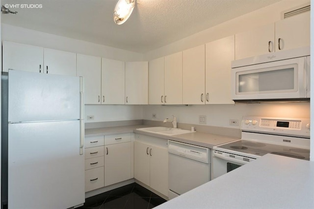 kitchen with white cabinetry, white appliances, and sink