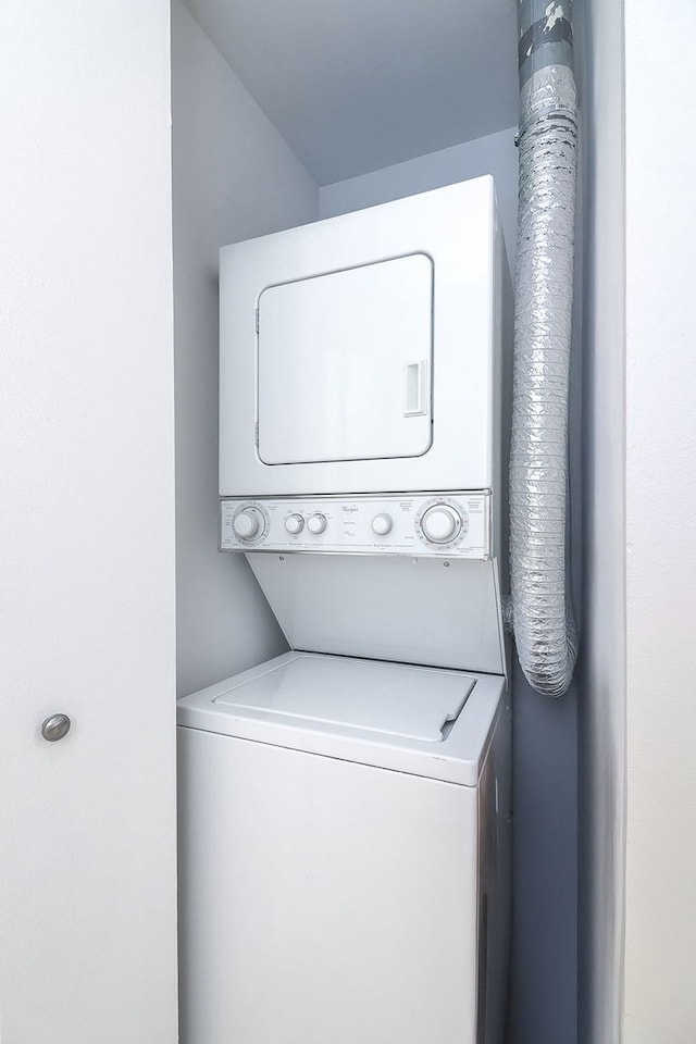 laundry area featuring stacked washing maching and dryer