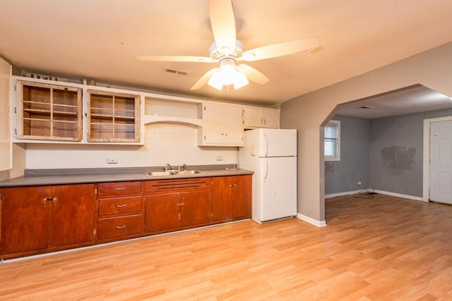 kitchen with ceiling fan, sink, light hardwood / wood-style flooring, white refrigerator, and decorative backsplash