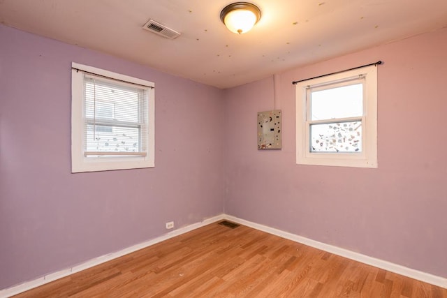 unfurnished room with light hardwood / wood-style flooring