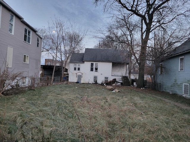 back of property featuring a lawn