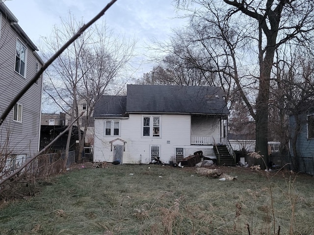 back of house with a lawn