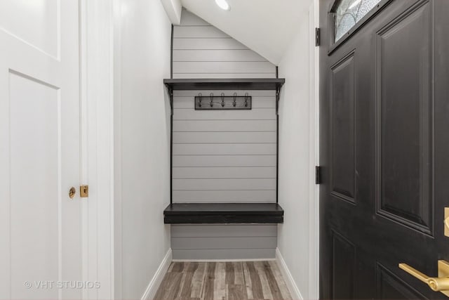 mudroom featuring hardwood / wood-style flooring and vaulted ceiling