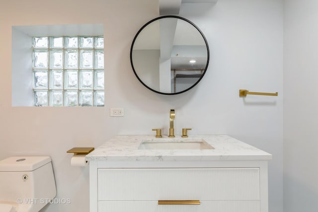 bathroom featuring toilet and vanity