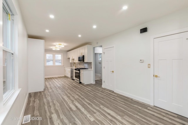 unfurnished living room featuring light wood-type flooring