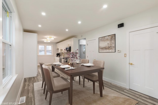 dining space featuring light wood-type flooring