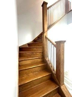 stairs featuring wood-type flooring