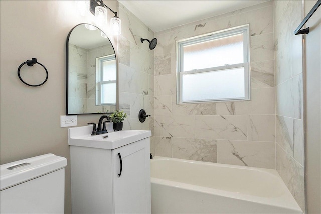 full bathroom featuring vanity, toilet, and tiled shower / bath combo