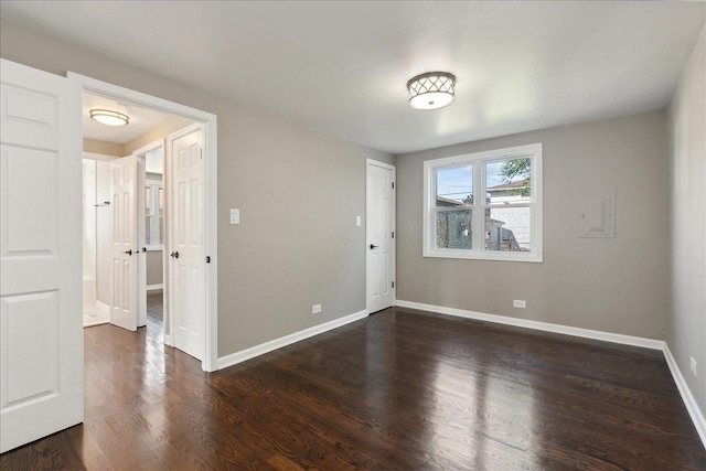 unfurnished room with dark hardwood / wood-style flooring