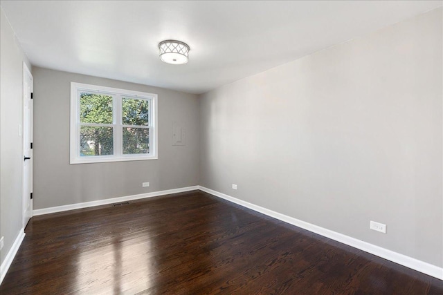 spare room with dark hardwood / wood-style floors