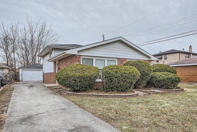 view of front of house featuring a detached garage, an outbuilding, and brick siding