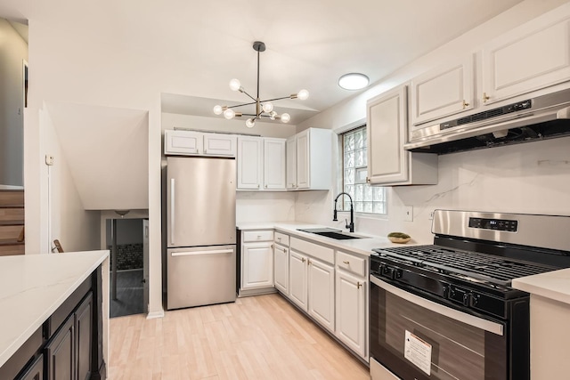 kitchen featuring a chandelier, white cabinetry, sink, and stainless steel appliances