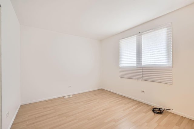 unfurnished room with light wood-type flooring