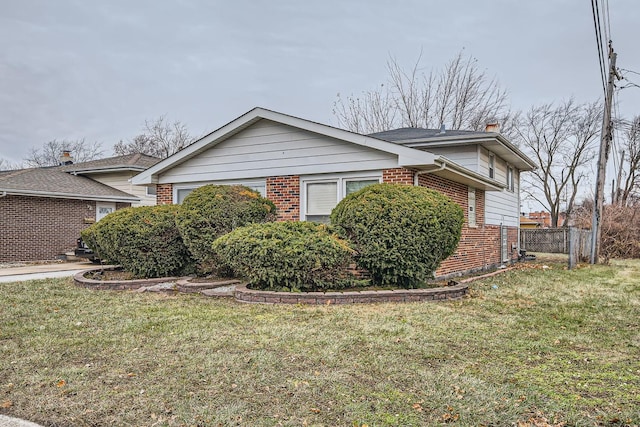 view of side of home featuring a lawn