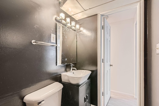 bathroom featuring hardwood / wood-style floors, vanity, and toilet