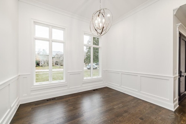 unfurnished dining area featuring dark hardwood / wood-style flooring, a notable chandelier, and crown molding