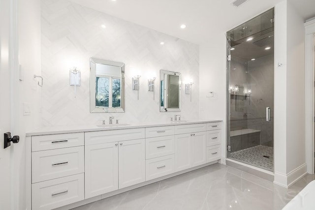 bathroom with vanity and a shower with door