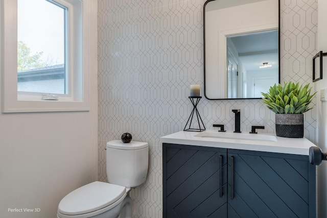 bathroom with backsplash, vanity, toilet, and a wealth of natural light