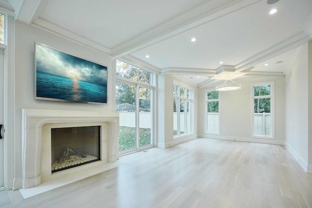 unfurnished sunroom with beamed ceiling, coffered ceiling, a wealth of natural light, and a high end fireplace