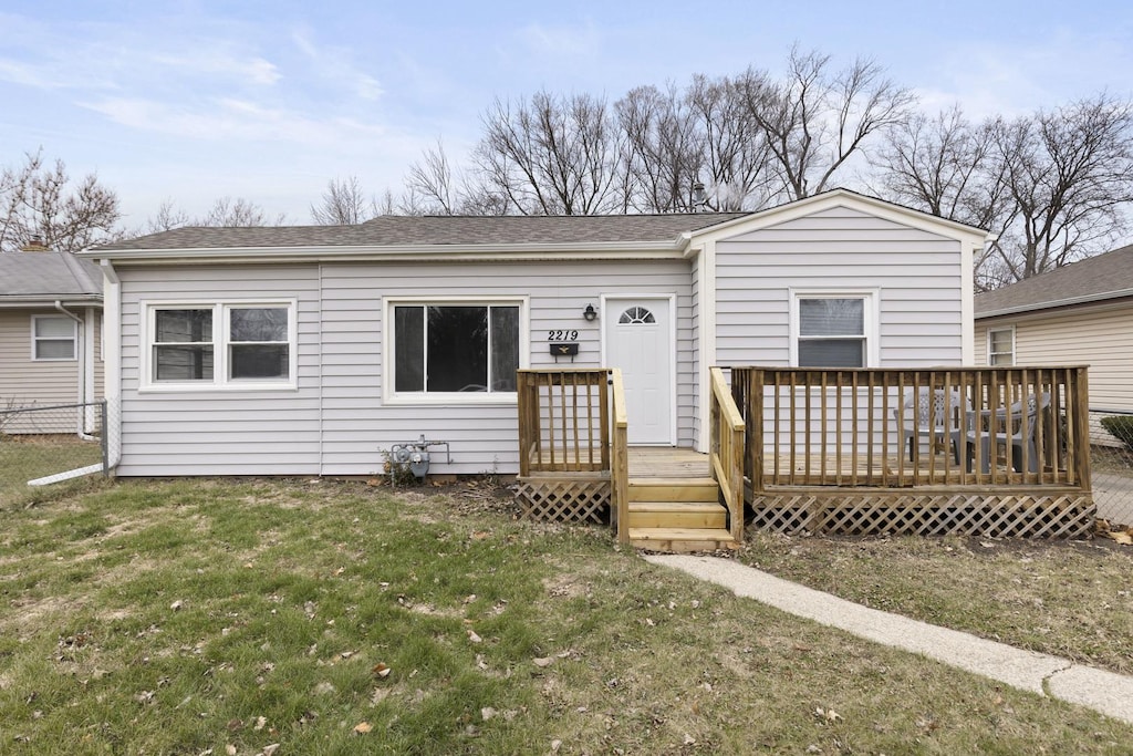 view of front of home featuring a front yard and a deck