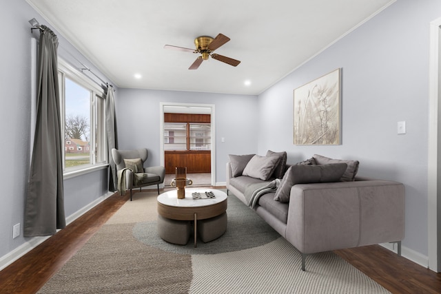 living room with hardwood / wood-style floors, ceiling fan, and ornamental molding