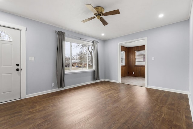 entrance foyer featuring dark hardwood / wood-style floors, ceiling fan, and a wealth of natural light