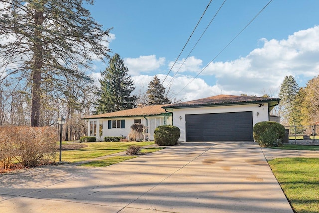 view of front of home featuring a garage and a front lawn