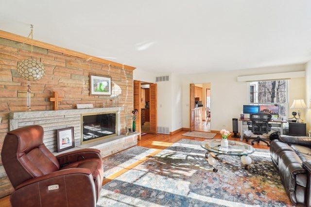 living room with a fireplace and light hardwood / wood-style flooring