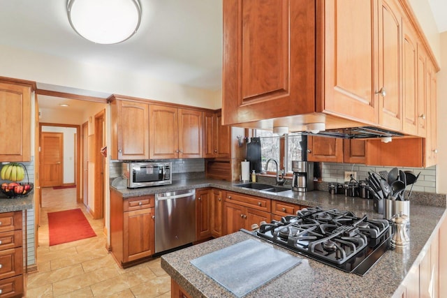 kitchen with decorative backsplash, appliances with stainless steel finishes, and sink