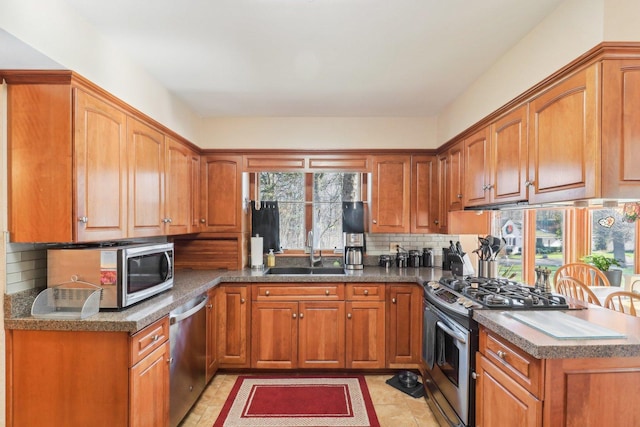 kitchen with sink, stainless steel appliances, and tasteful backsplash