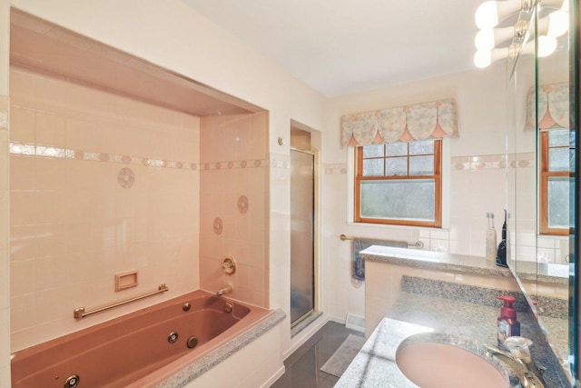 bathroom with vanity, plus walk in shower, and tile walls