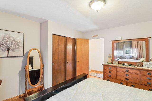 bedroom with a closet and hardwood / wood-style floors