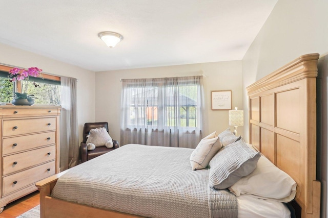 bedroom with light wood-type flooring and multiple windows