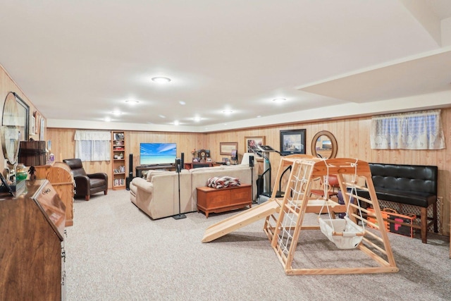 living room featuring carpet flooring and wood walls