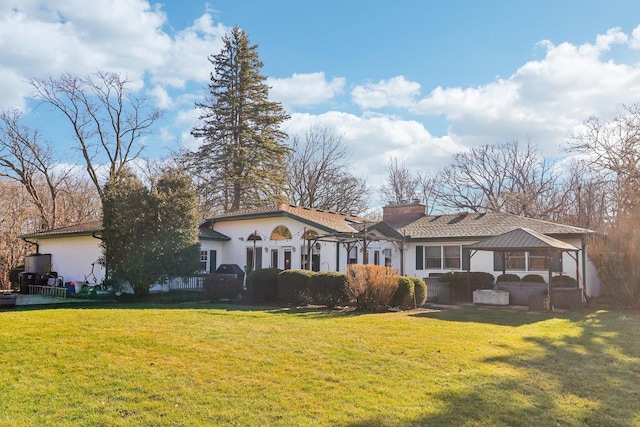 view of front of property featuring a gazebo and a front lawn