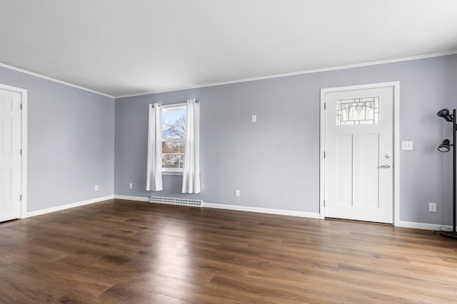 foyer entrance with dark hardwood / wood-style floors, baseboard heating, and crown molding