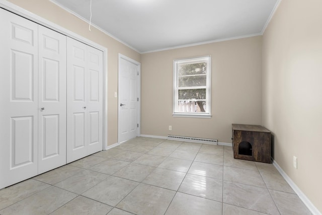 unfurnished bedroom featuring a baseboard heating unit, light tile patterned floors, crown molding, and a closet