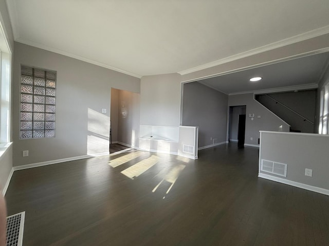 empty room with dark hardwood / wood-style flooring and ornamental molding