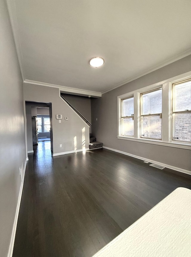 unfurnished living room featuring dark hardwood / wood-style floors and crown molding