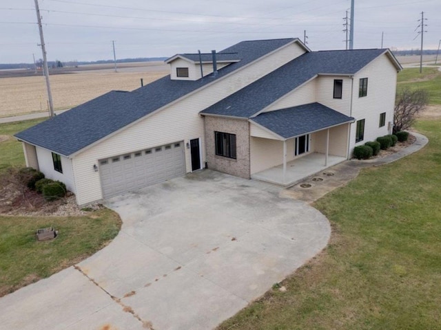 view of front facade featuring a porch, a front yard, and a garage