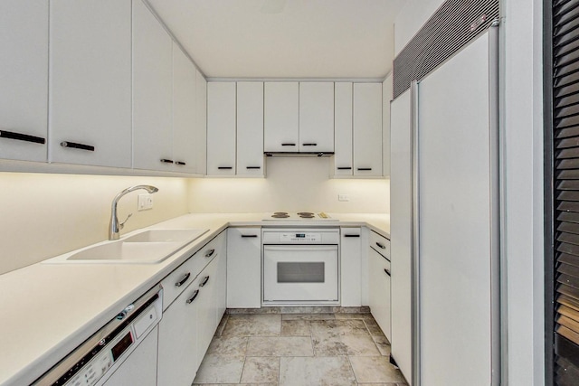 kitchen with white cabinets, white appliances, and sink