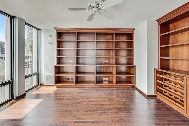 interior space featuring dark hardwood / wood-style flooring, expansive windows, and ceiling fan