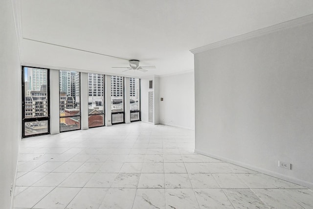 spare room with floor to ceiling windows, ceiling fan, and ornamental molding