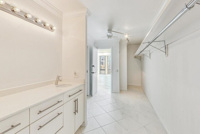 bathroom featuring ceiling fan, vanity, and ornamental molding