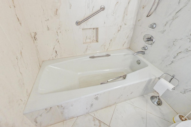 bathroom with tile walls and tiled tub