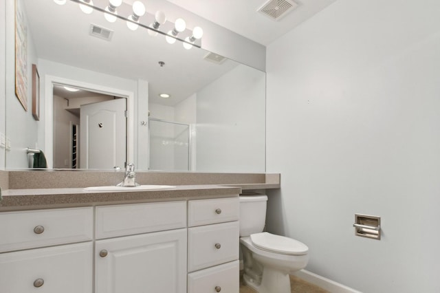 bathroom with vanity, an enclosed shower, and toilet