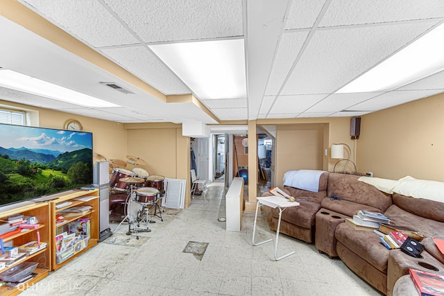 living room with a drop ceiling