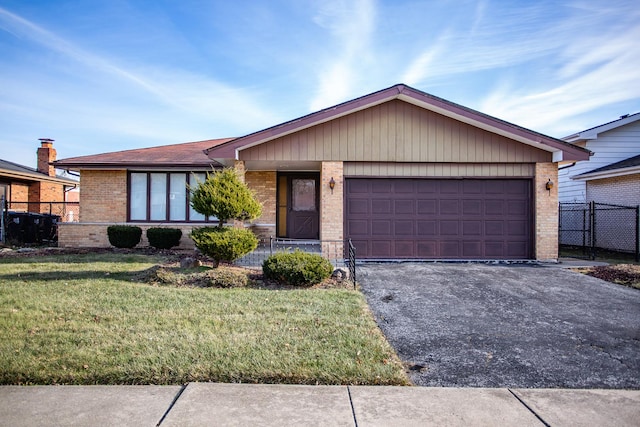 ranch-style home featuring a garage and a front lawn